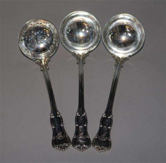 A pair of silver Edwardian silver sauce ladles by Goldsmiths & Silversmiths and a silver sifter spoon.